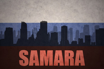 abstract silhouette of the city with text Samara at the vintage russian flag