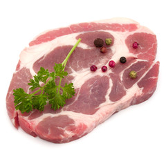 Raw pork neck chop meat with parsley herb leaves and peppercorn