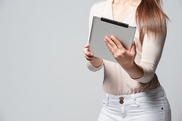 Portrait of smiling young business woman holding a tablet