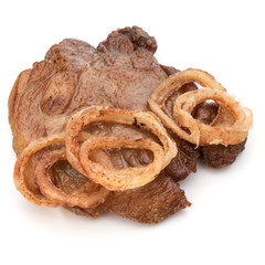 Cooked fried pork meat with onion slices garnish isolated on whi