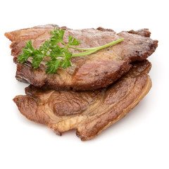Cooked fried pork meat with parsley herb leaves garnish isolated