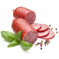 Salami smoked sausage, basil leaves and peppercorns isolated on
