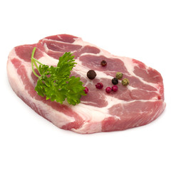 Raw pork neck chop meat with parsley herb leaves and peppercorn