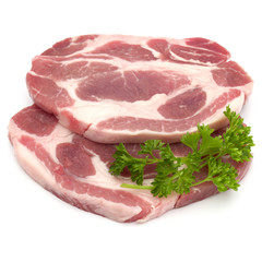Raw pork neck chop meat with parsley herb leaves garnish isolate