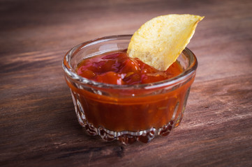 chips and sauce on wooden background