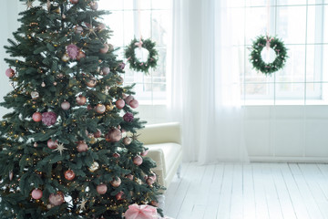 Fototapeta na wymiar Christmas decorations with christmas tree and gifts in white living room