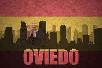 abstract silhouette of the city with text Oviedo at the vintage spanish flag