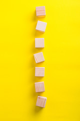 wooden blocks on yellow background