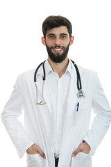 Fototapeta premium Young serious handsome bearded doctor with white coat and stethoscope.