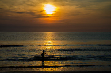 Fisherman casting a net at dawn
