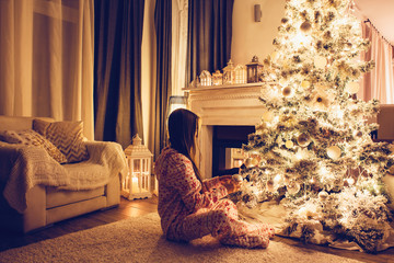 Child near Christmas tree