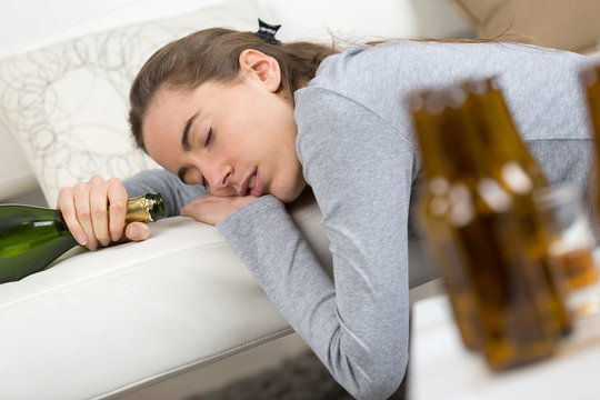 drunk young woman sleeping on bed