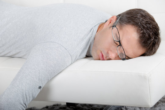 Close Up Of A Man Sleeping On Sofa