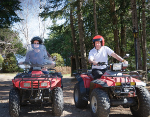young couple riding a quad in Quebec country, Canada