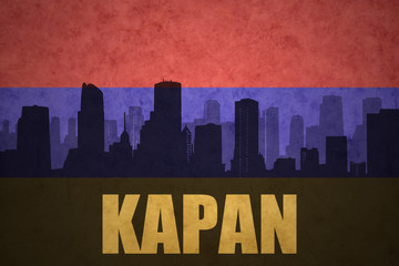 abstract silhouette of the city with text Kapan at the vintage armenian flag