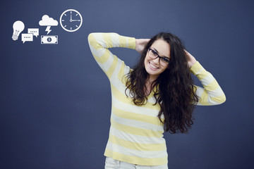 Cheerful young woman with background with drawn business chart, arrow and icons.