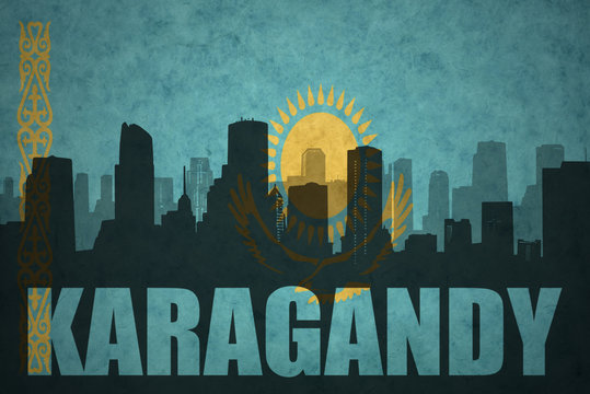 abstract silhouette of the city with text Karagandy at the vintage kazakhstan flag