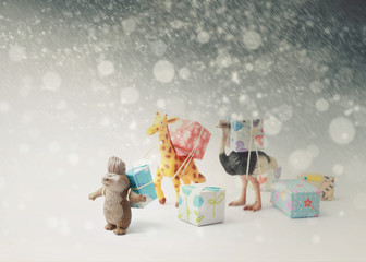 Animals(miniature) carrying gift boxes.Christmas and Happy new year concept background in vintage color.