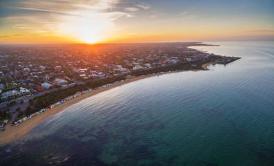 Aerial view of sunrise at Brighton Beach showing the suburb and bathing boxes. Melbourne, Victoria, Australia