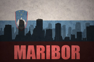 abstract silhouette of the city with text Maribor at the vintage slovenian flag
