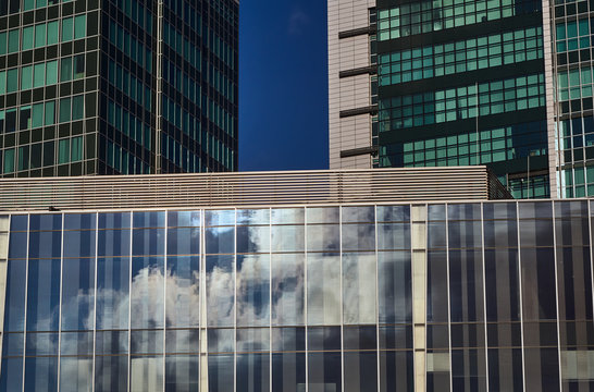  Reflection of clouds in the glass facade of modern skyscrapers in Poznan