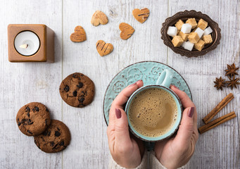  Women drinking coffee with milk and eating cookies top view