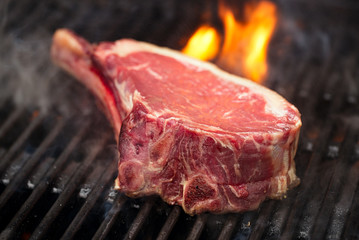 food meat - beef steak on bbq barbecue grill with flame