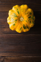 Yellow squash on a wooden  background. Top view,  Colorful festive still life. Copyspace. 