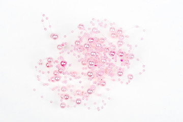 Christmas, wedding, vanetine, greeting decoration – big and small pink pearls on the line (string). Pearl decoration isolated on white background. Pink balls.