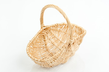 Fototapeta na wymiar Empty wooden woven fruit/bread basket on white background. Wicker basket. Plaited container. Natural wood (brown) color. Winter, Christmas, New Year, enterteinment place decoration. Top, side view.