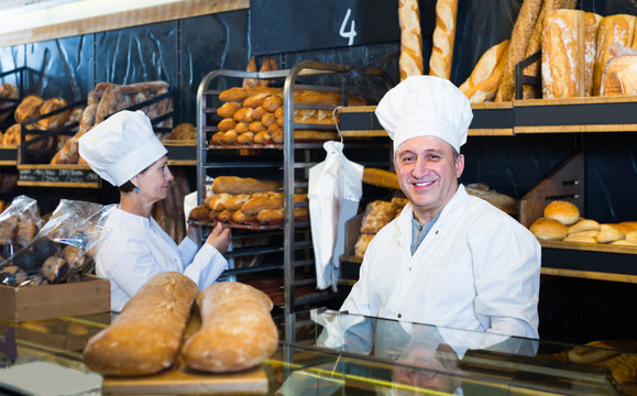 staff offering fresh baguettes