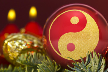 Red bauble with the golden shape of a YingYang symbol. (series)