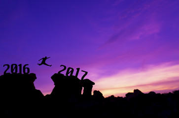Silhouette man jumping between 2016 and 2017 years.