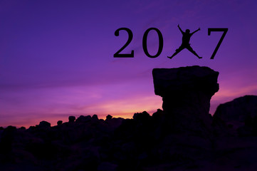 Silhouette man jumping between 2017 years.