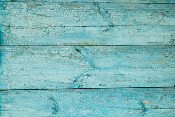 Old weathered wood plank painted in blue