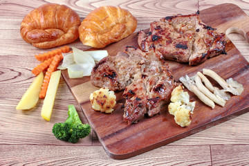 Home made ,Pork steak and mixed vegetables,croissants on butcher