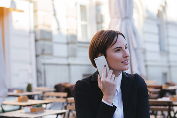Fototapeta premium Happy young lady talking on mobile phone.