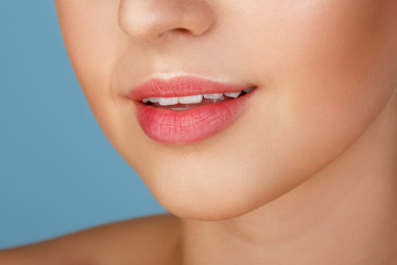 Obraz premium Perfect natural lip makeup. Close up macro photo with beautiful female mouth. Plump full lips. Close-up face detail. Perfect clean skin, light fresh lip make-up. Beautiful spa tender lip