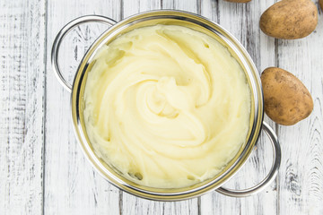 Wooden table with Mashed Potatoes (selective focus)