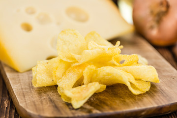 Cheese and Onion Potato Chips (selective focus) on vintage woode