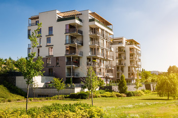 Modern block of flats in the green park. Eco-friendly living in a city.
