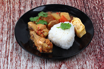 Rice with boiled chicken,omelet roll topped Japanese yellow curr