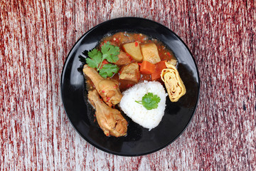 Rice with boiled chicken,omelet roll topped Japanese yellow curr