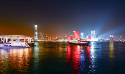 Hong Kong skyscrapers at night with boats in movement
