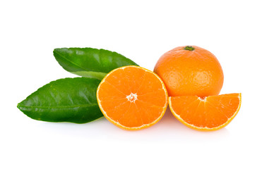 whole and cut ripe orange with leaf on white background