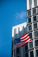 American Flag in front of Urban High Rise Building