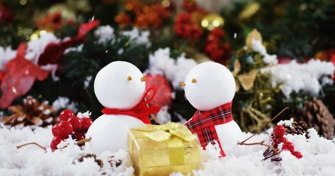 Two snowman with fake snow