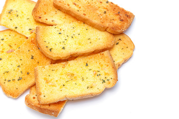 Stack of crunchy garlic bread on white background