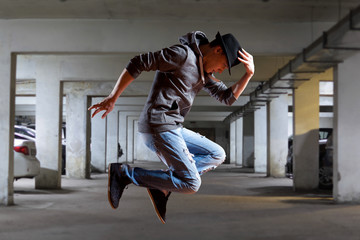 Man break dancing on wall background