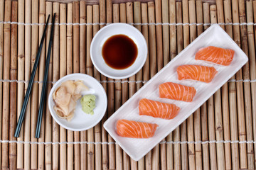 Japanese food - salmon sushi served with side dish.